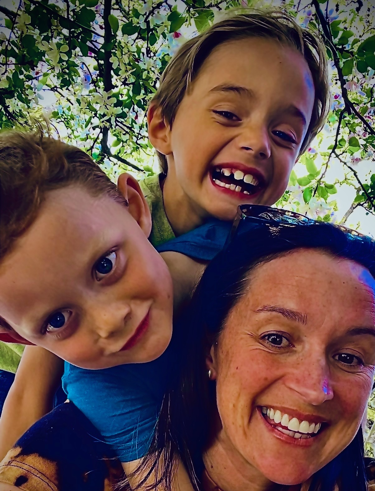 Kayla Maxwell smiling outdoors with her children